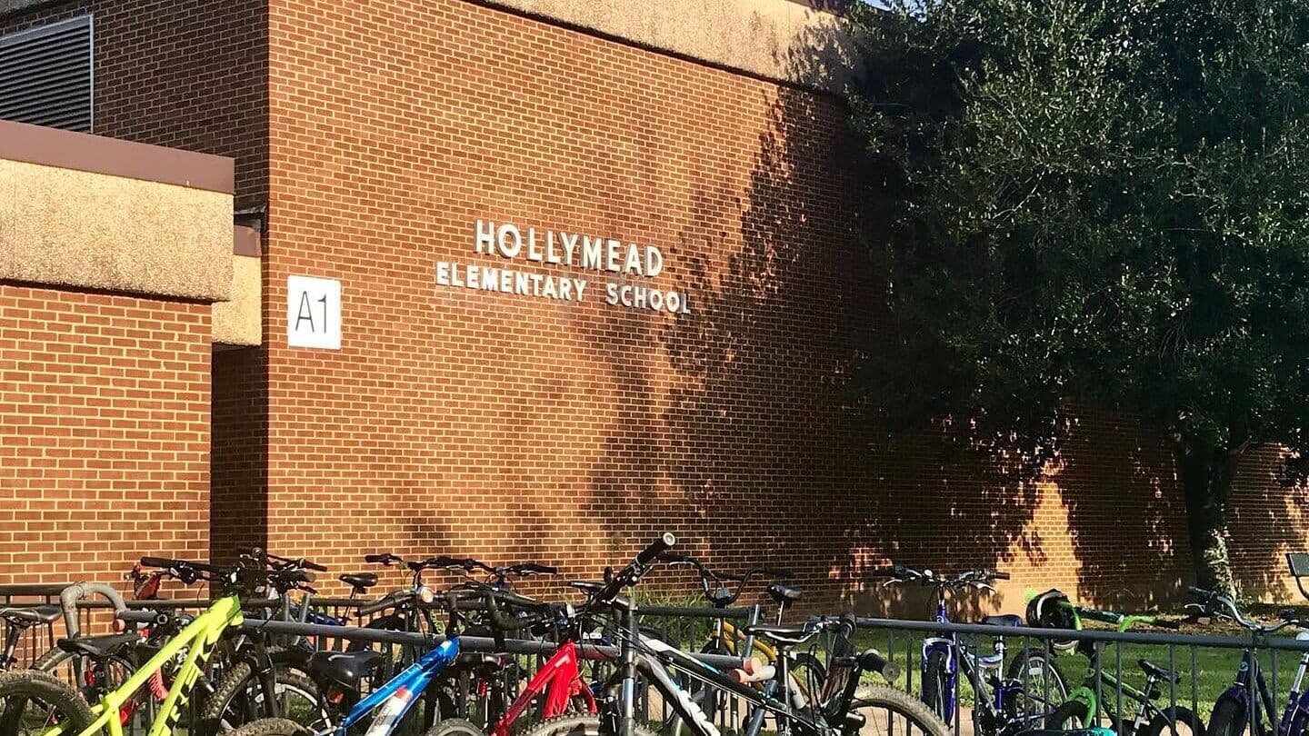 The brick exterior of Hollymead Elementary School with a rack of children's bicycles parked out front